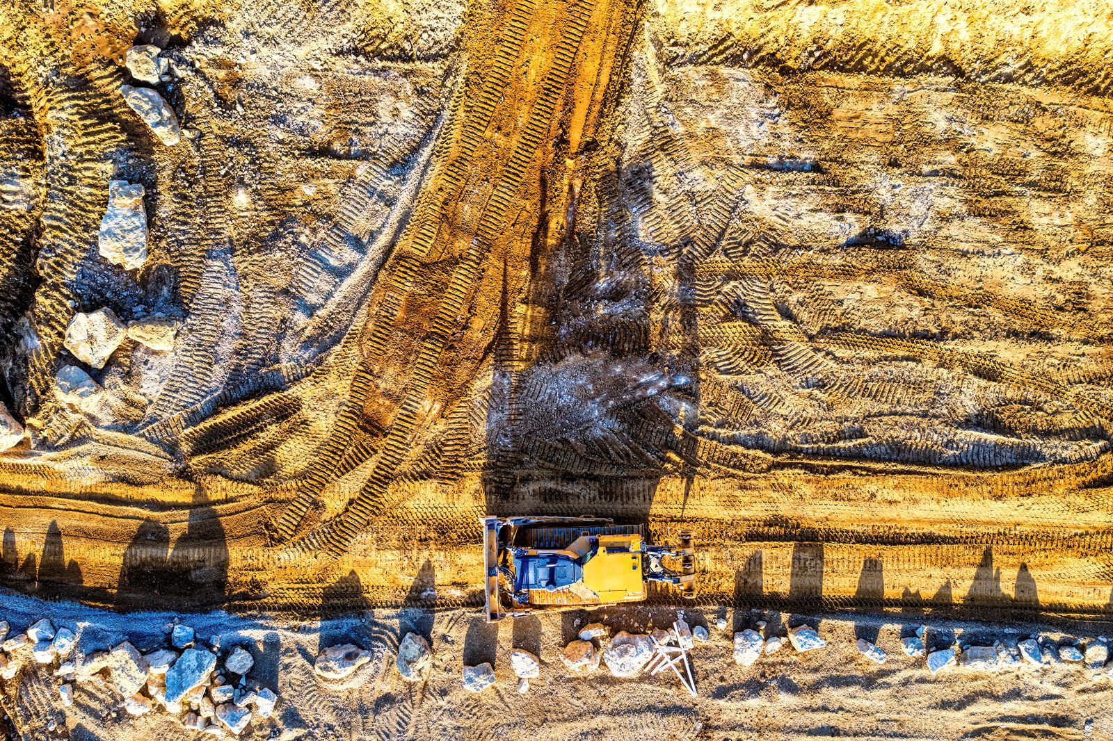 Aerial view of an excavator working on a rural earthworks site