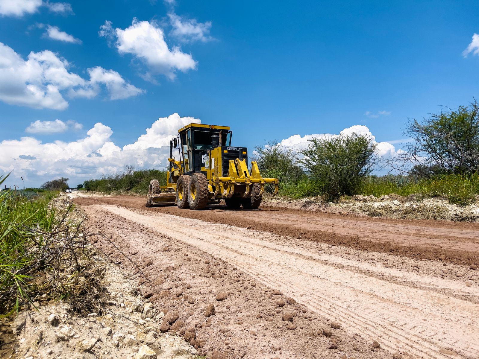 Bulldozer shaping a rural dirt road